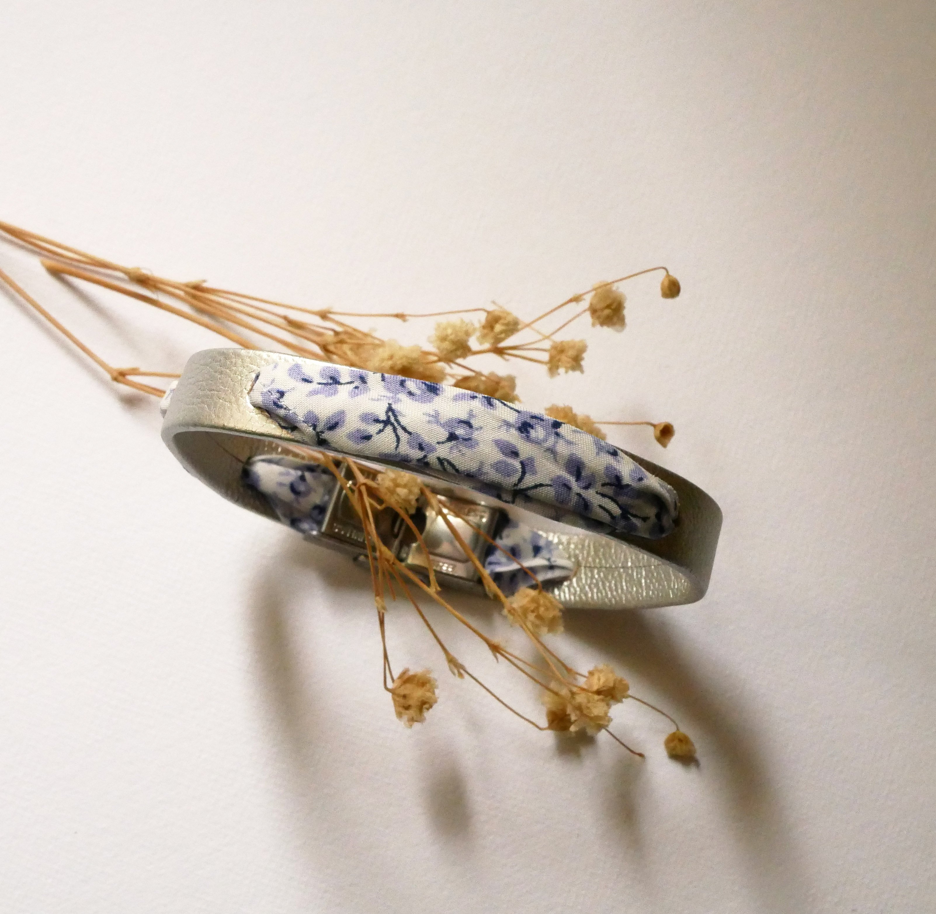 Florâme-armband med blå blommor i libertyband på silverläder